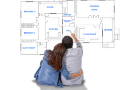 33471984 - young attractive couple in love happy together planning and pointing  blueprints , floor plan and design of new house, home, flat or apartment in real state concept